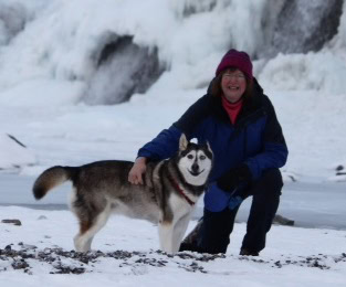 Woman with her dog in snowy landscape, community support and compassion.
