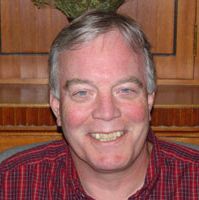 A compassionate leader from Catholic Community Services smiling in a professional setting.